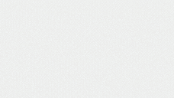 Light gray speckled texture with a subtle vignette, fading darker toward the edges.